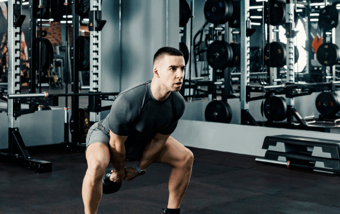 young athlete doing kettlebell swings