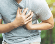 man grabbing his chest in pain