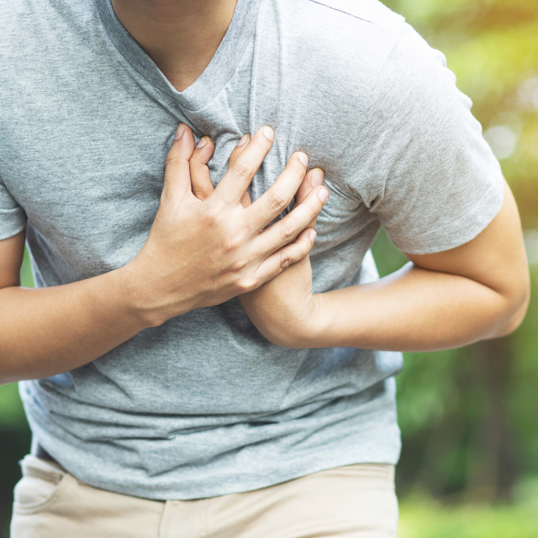 man grabbing his chest in pain
